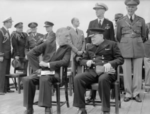 President_Roosevelt_and_Winston_Churchill_seated_on_the_quarterdeck_of_HMS_PRINCE_OF_WALES_for_a_Sunday_service_during_the_Atlantic_Conference,_10_August_1941._A4815.jpg